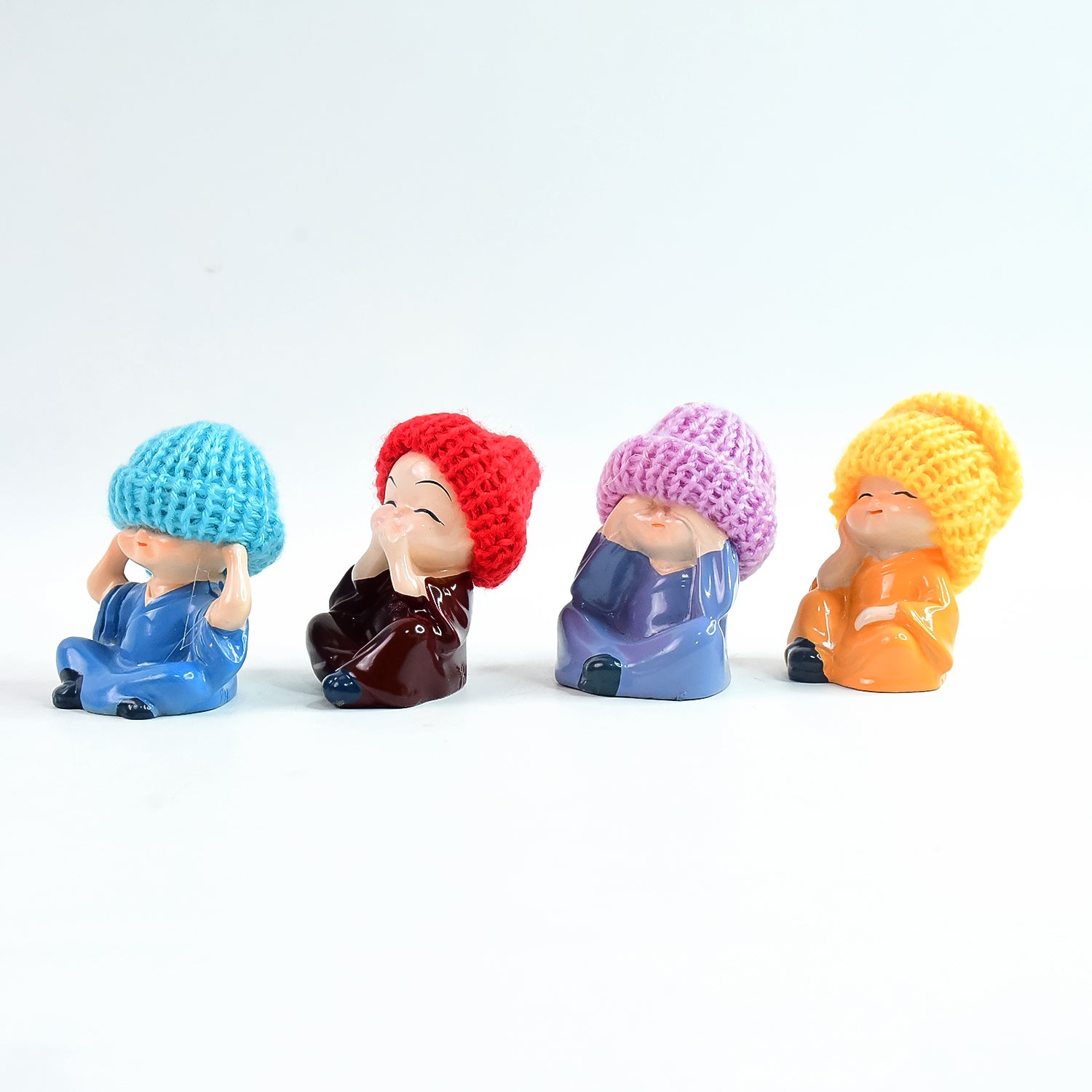 Set of four decorative resin Monk Buddha showpieces by Wukusy, featuring traditional straw hats for home decor.