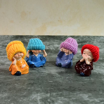 Set of four decorative resin Monk Buddha showpieces with traditional straw hats, ideal for home decor by Wukusy.
