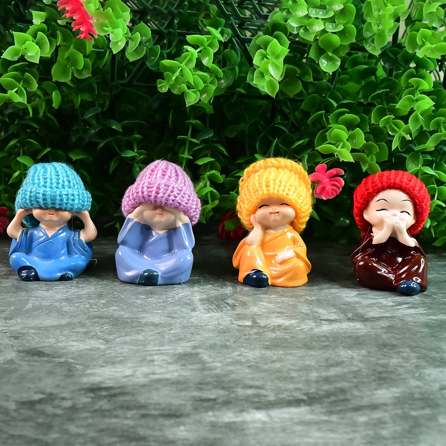Set of four decorative resin Monk Buddha showpieces with traditional straw hats, ideal for home decor by Wukusy.