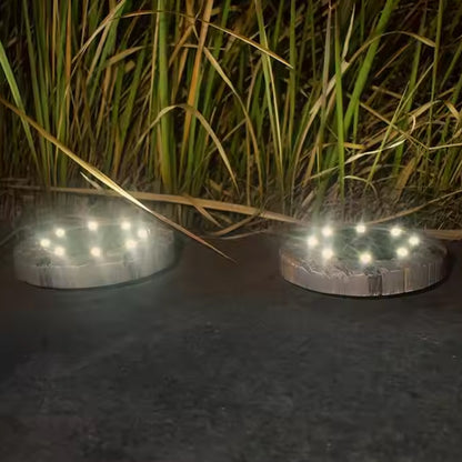 Wukusy Disk Lights Slate outdoor solar pathway lights with 4 LED bulbs, heavy-duty design for garden or walkway illumination.