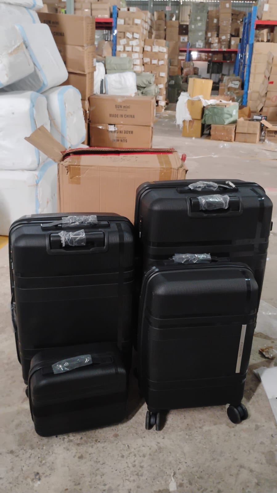 Set of three Wukusy hard-shell trolley luggage bags in assorted colors, featuring durable wheels and telescopic handles for travel.