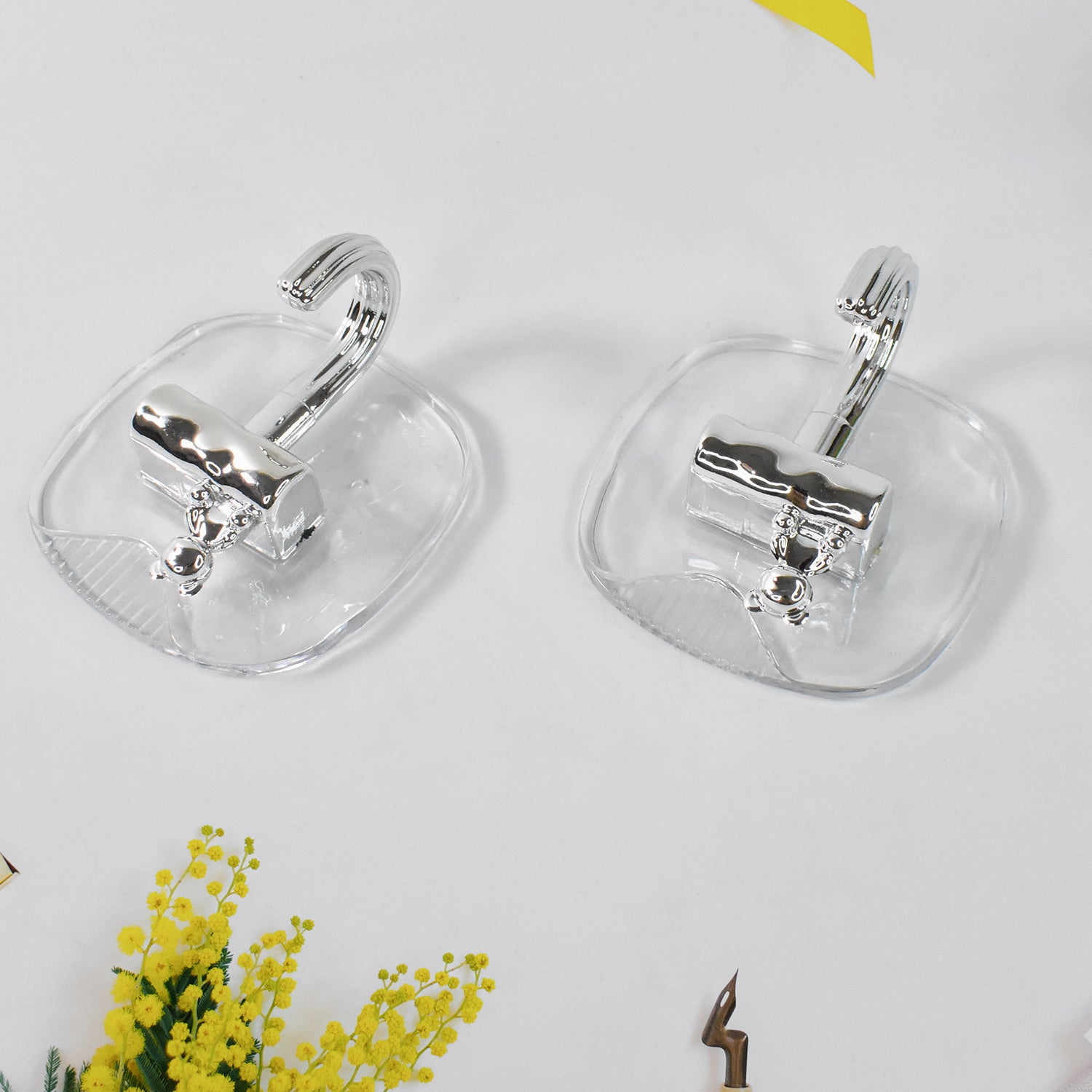 Two large plastic self-adhesive wall hooks from Wukusy for home improvement, ideal for hanging lightweight items.