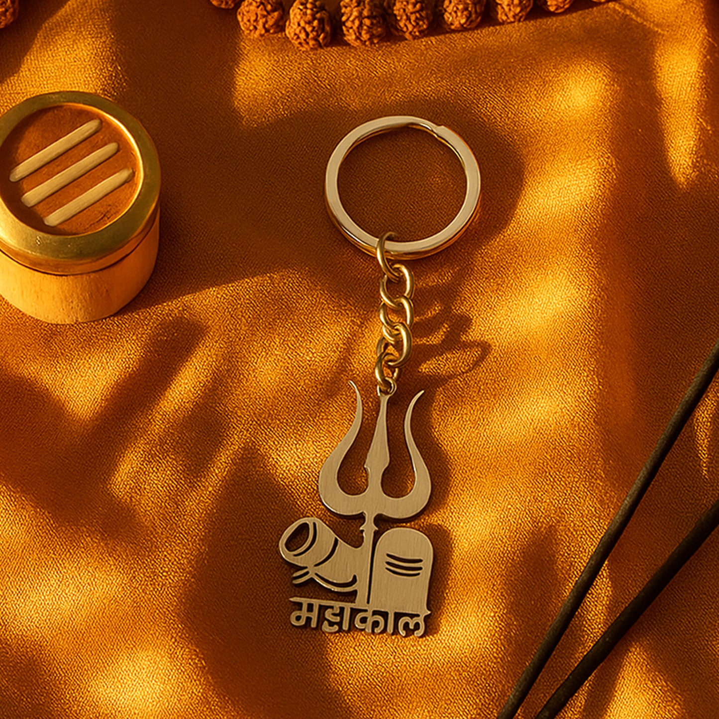 Wukusy Mahakal Trishul Shivling design metal keychain, featuring intricate Hindu religious symbols, on a plain background.