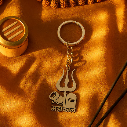 Wukusy Mahakal Trishul Shivling design metal keychain, featuring intricate Hindu religious symbols, on a plain background.