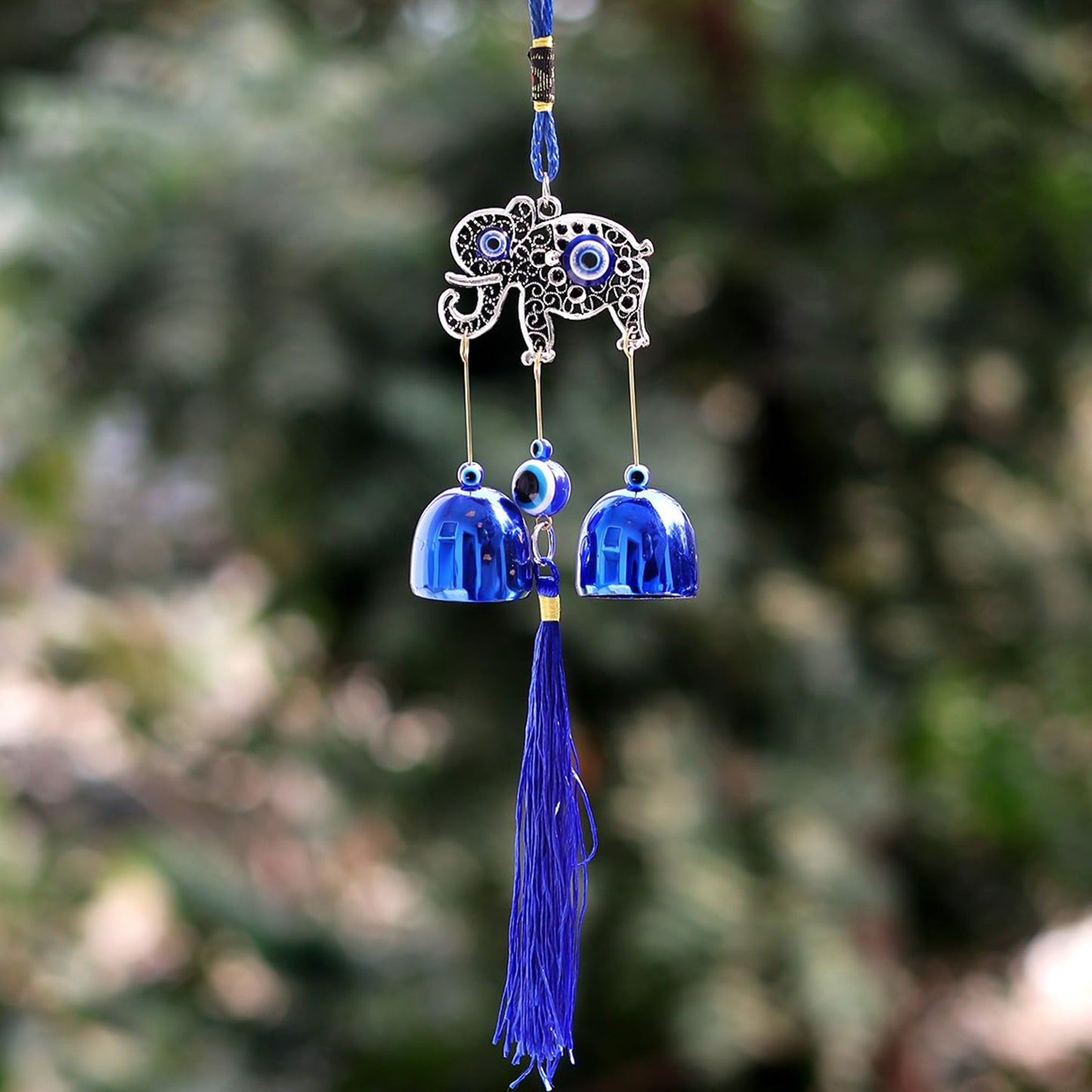 Wukusy Metal Evil Eye Wind Chime Bells in mixed designs hanging outdoors for home decor and protection.