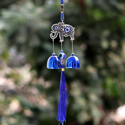 Wukusy Metal Evil Eye Wind Chime Bells in mixed designs hanging outdoors for home decor and protection.