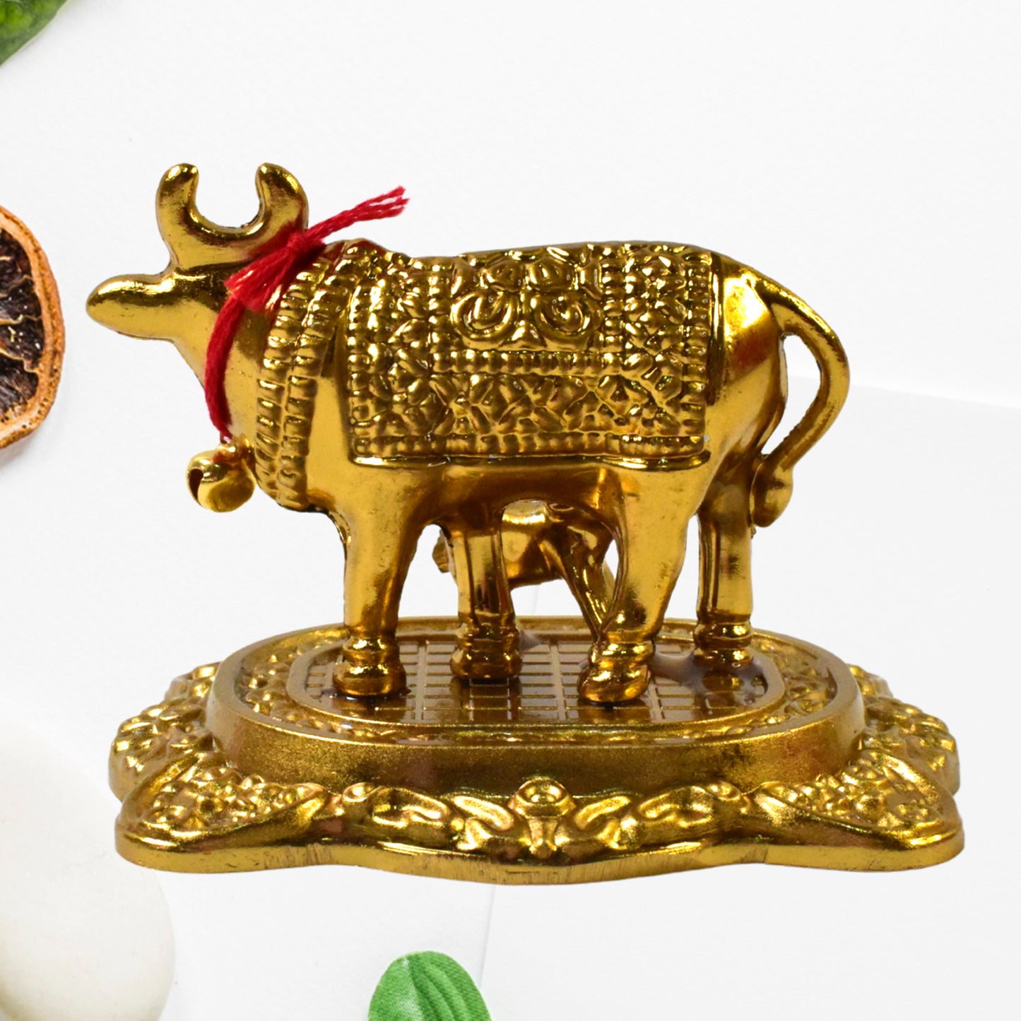 Golden metal Kamdhenu cow with calf sculpture by Wukusy, decorative home improvement figurine, detailed gold finish.
