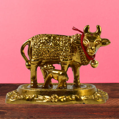 Golden metal Kamdhenu cow with calf sculpture by Wukusy, decorative home improvement figurine for auspicious decor.