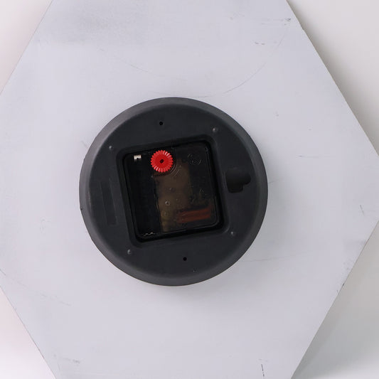 Modern geometric hexagon wall clock by Wukusy, showcasing a stylish design for home decor in a close-up view.