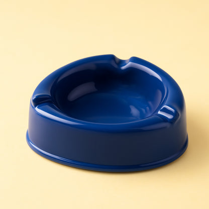 Dark blue plastic ashtray by Wukusy, featuring a sleek design, for use in home or outdoor spaces.