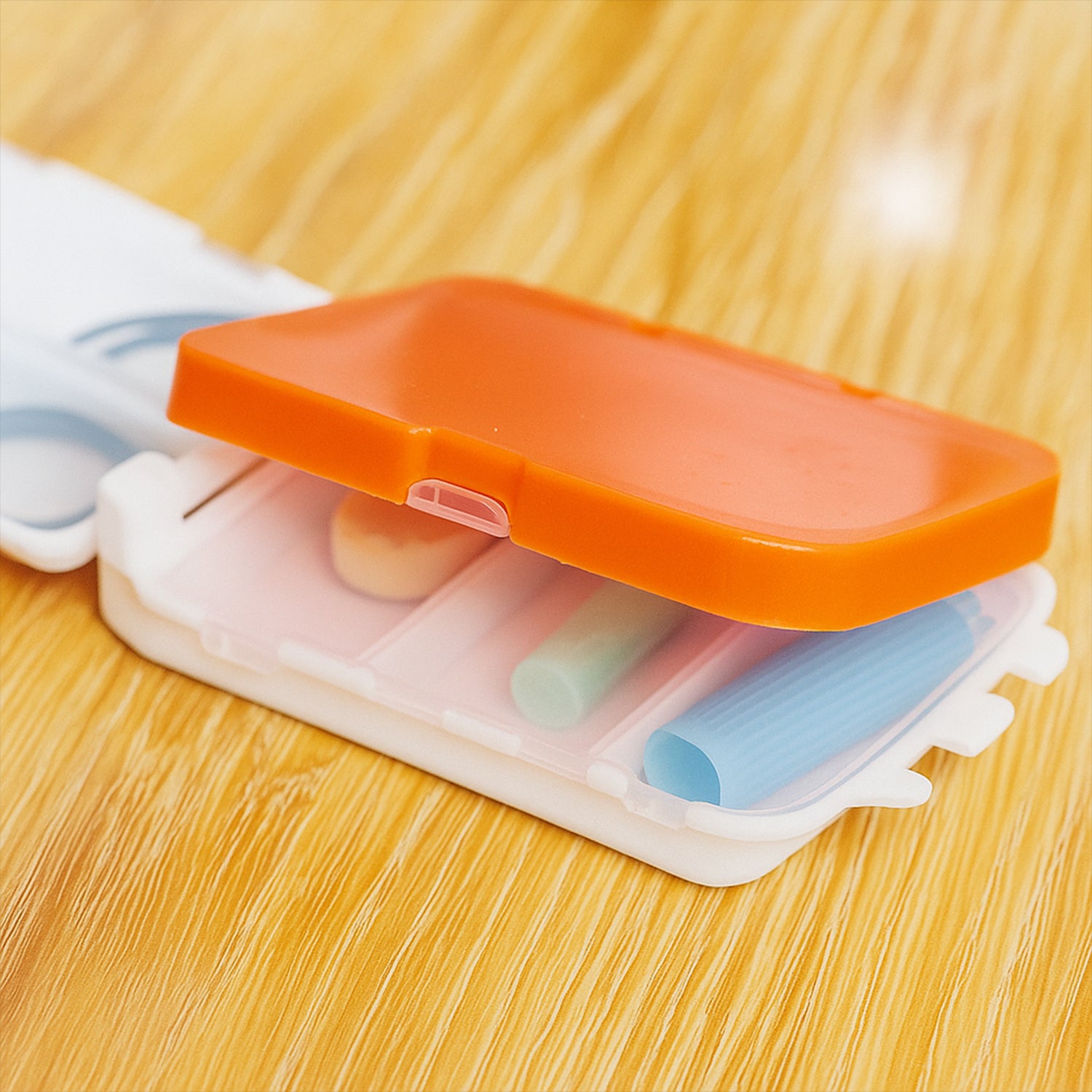 Wukusy portable dual-sided pill organizer box with multiple compartments for medication storage, ideal for home use.