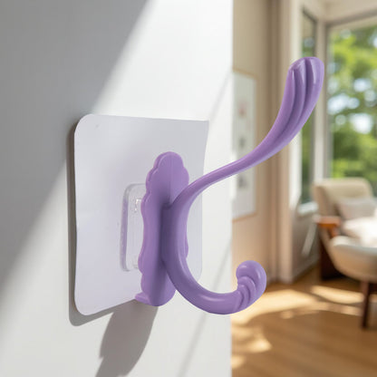 Wukusy heavy-duty self-adhesive decorative wall hook attached to a wall, designed for home improvement and hanging items.