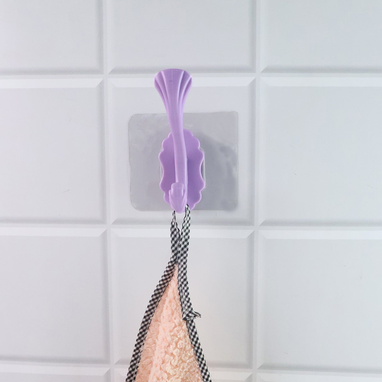 Wukusy heavy-duty self-adhesive decorative wall hook for home improvement, mounted on a wall for hanging items.