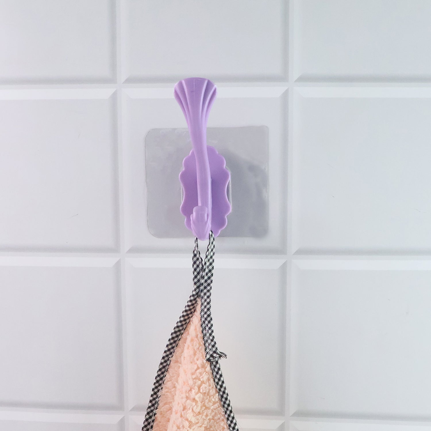 Wukusy heavy-duty self-adhesive decorative wall hook for home improvement, mounted on a wall for hanging items.