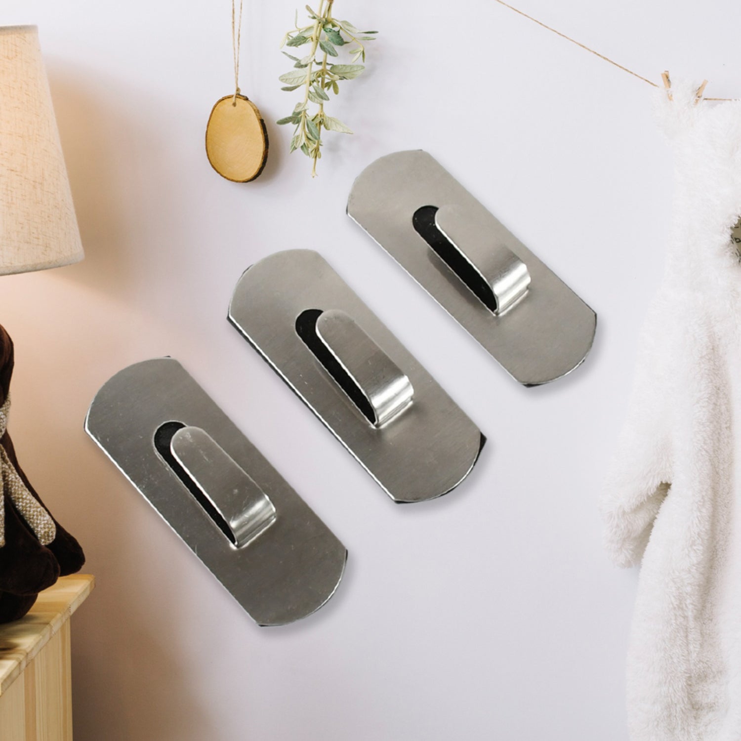 Stainless steel Wukusy heavy-duty self-adhesive wall hooks for hanging robes, towels, coats, and kitchen or bathroom items.