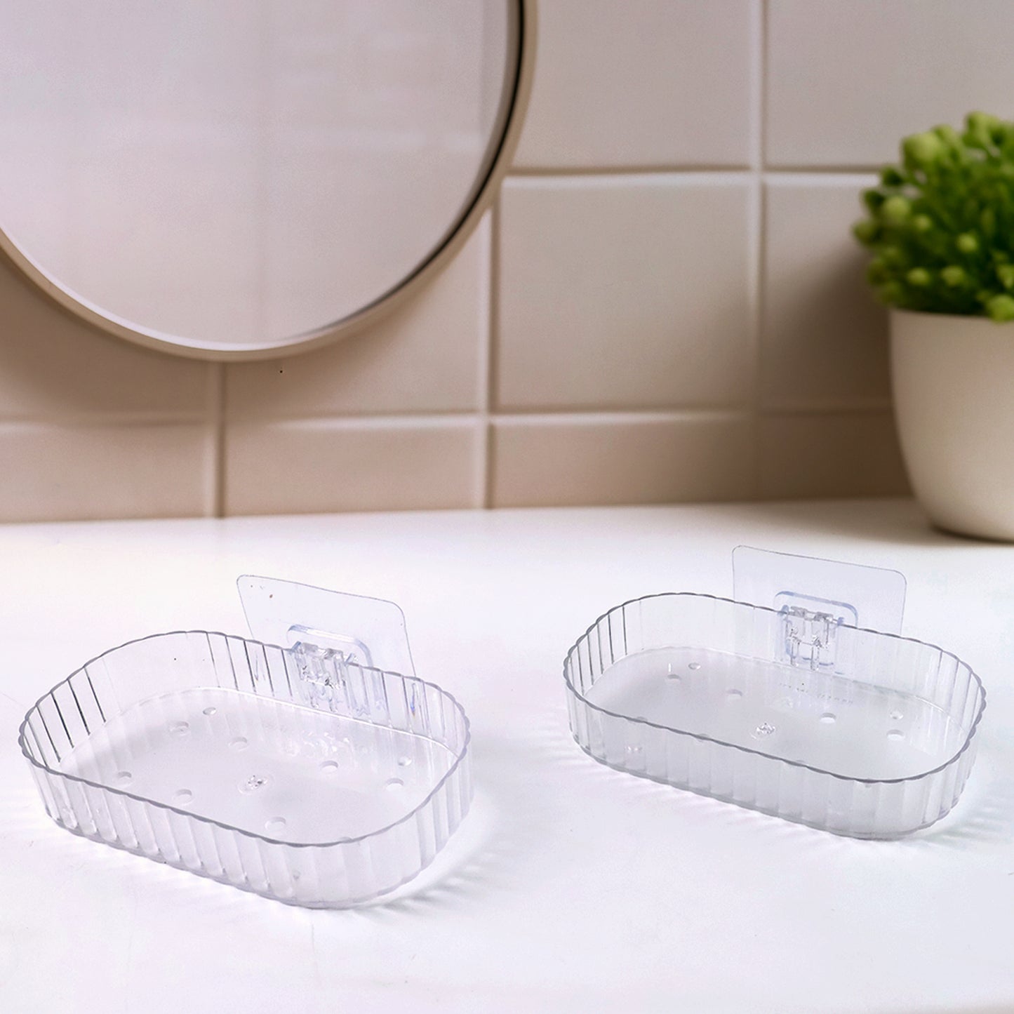 Two transparent, wall-mounted soap dish holders with self-adhesive backing, designed for bathroom wall mounting by Wukusy.