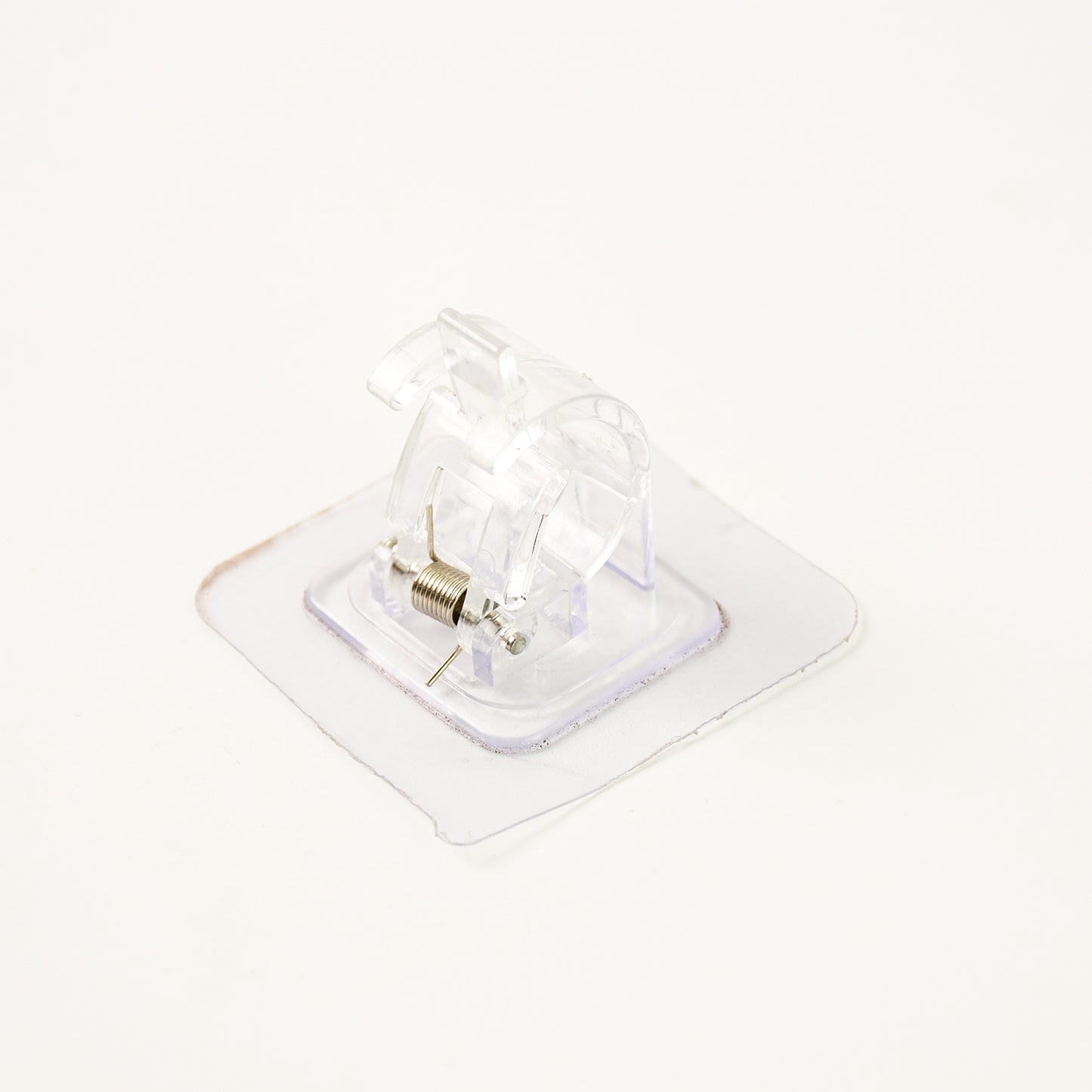 Self-adhesive transparent wall with spring-loaded anti-slip clip by Wukusy for home improvement, shown attached to a wall.