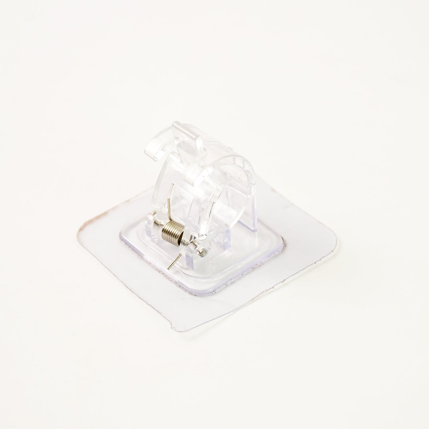 Self-adhesive transparent wall with spring-loaded anti-slip clip by Wukusy for home improvement, shown attached to a wall.