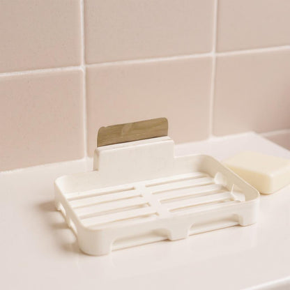 Wall-mounted plastic soap dish with drain slots, self-adhesive design by Wukusy, suitable for home improvement and bathroom organization.