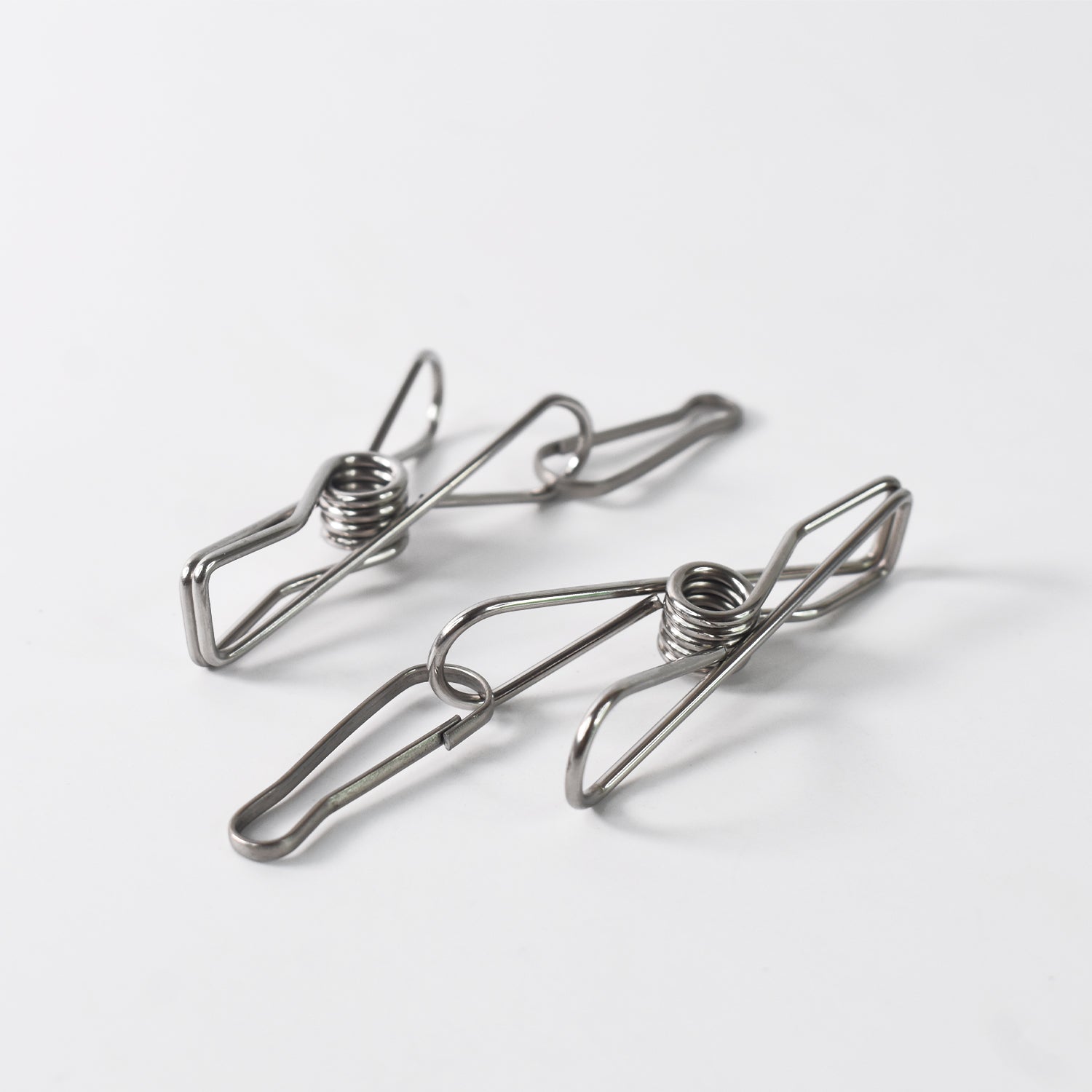 Stainless steel clothes pegs with one rope for hanging laundry, designed for durable home improvement use.