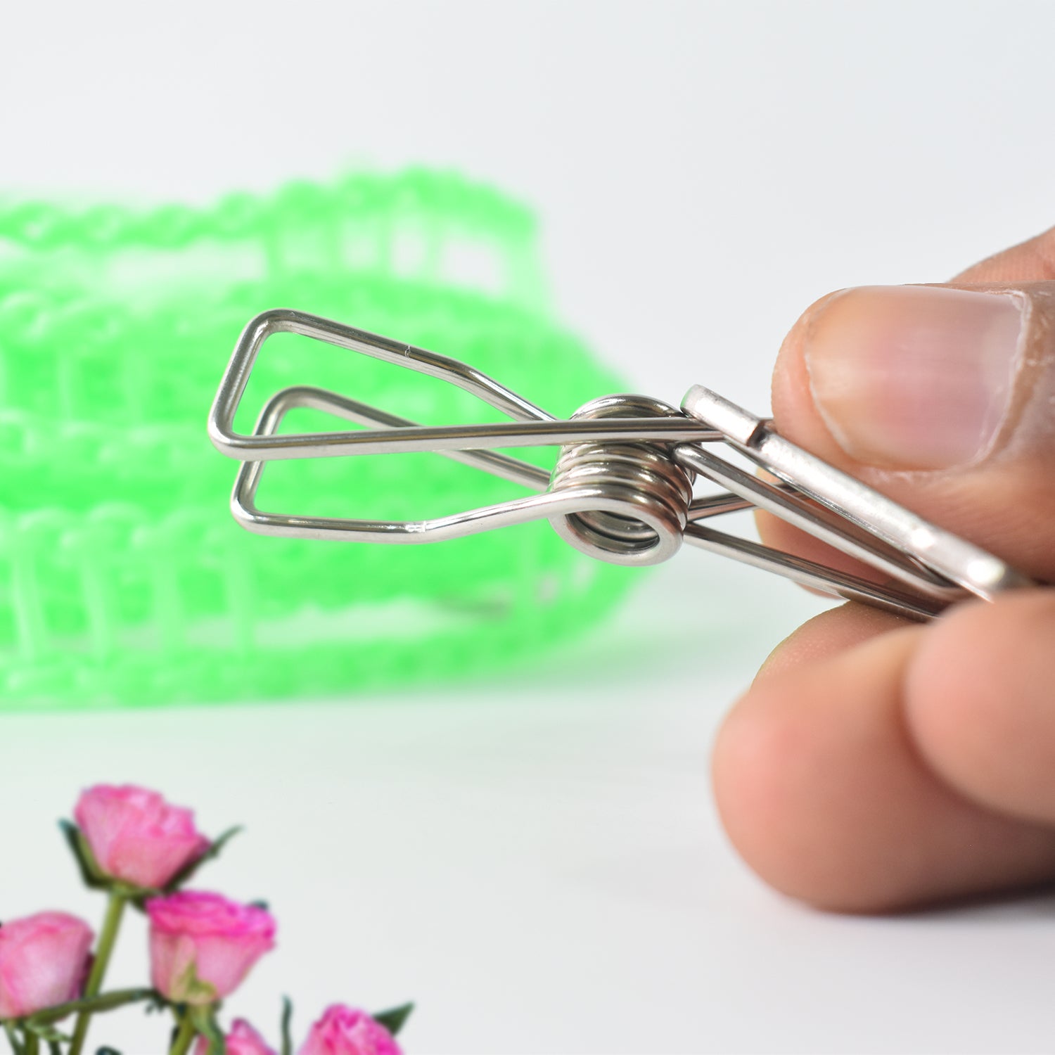Wukusy stainless steel clothes pegs attached to a rope for hanging laundry, ideal for home improvement and outdoor use.