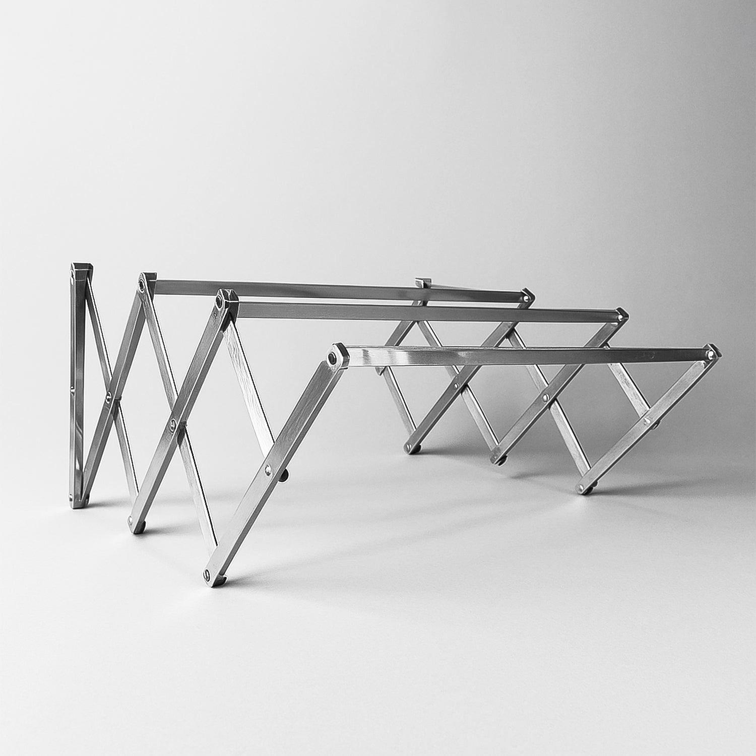 Wukusy stainless steel wall-mounted folding clothes drying rack, ideal for home improvement and space-saving laundry organization.