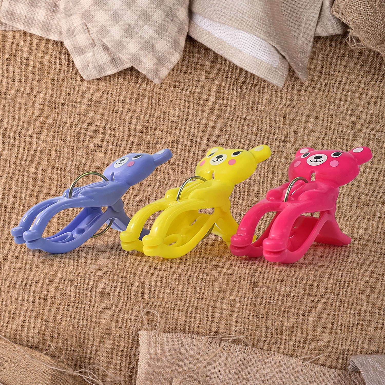 Set of three Wukusy windproof plastic towel clips for outdoor use, ideal for securing towels on clotheslines or outdoor furniture.