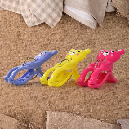 Set of three Wukusy windproof plastic towel clips for outdoor use, ideal for securing towels on clotheslines or outdoor furniture.