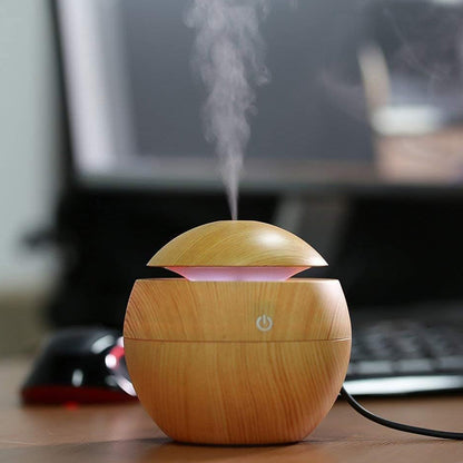 Wukusy ultrasonic aromatherapy humidifier on a desk, 130ml capacity, USB-powered, for home improvement and air moisture.