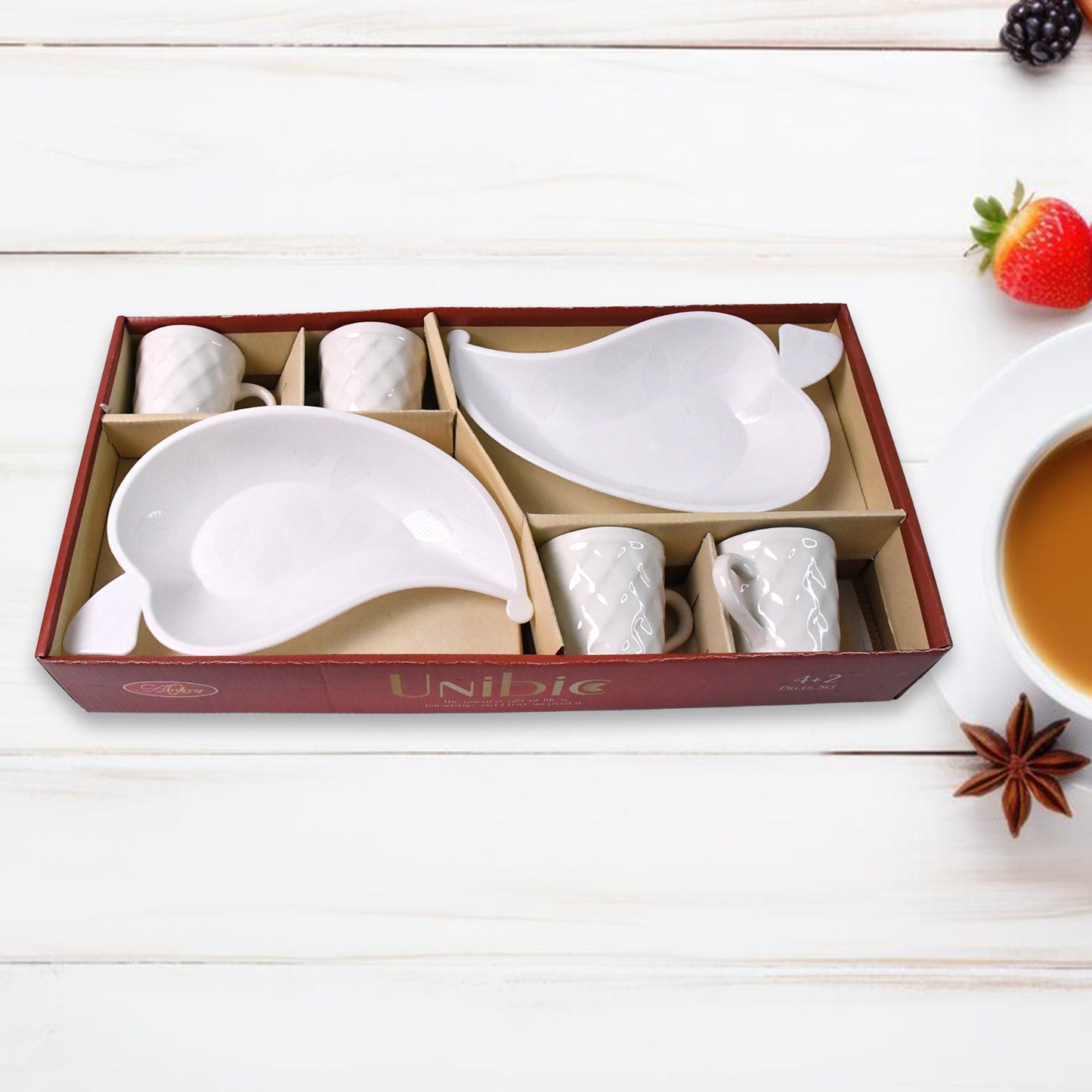 Set of six Unibic ceramic tea cups with a plastic leaf-shaped tray, arranged on a wooden surface for home improvement use.
