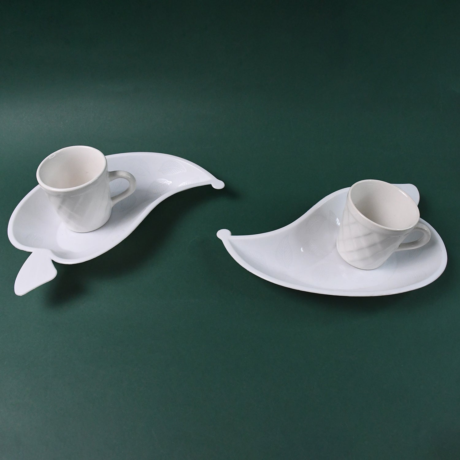 Set of six Unibic ceramic tea cups with a plastic leaf-shaped tray, perfect for serving tea in a stylish home improvement setting.