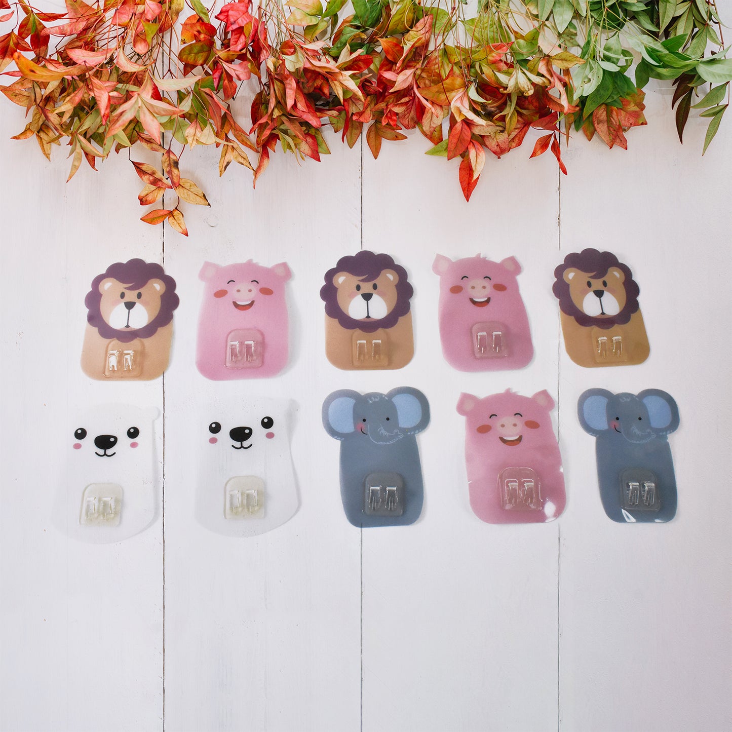 Set of 10 Wukusy wall-mounted cartoon hooks with self-adhesive backing for home organization and decorative storage solutions.