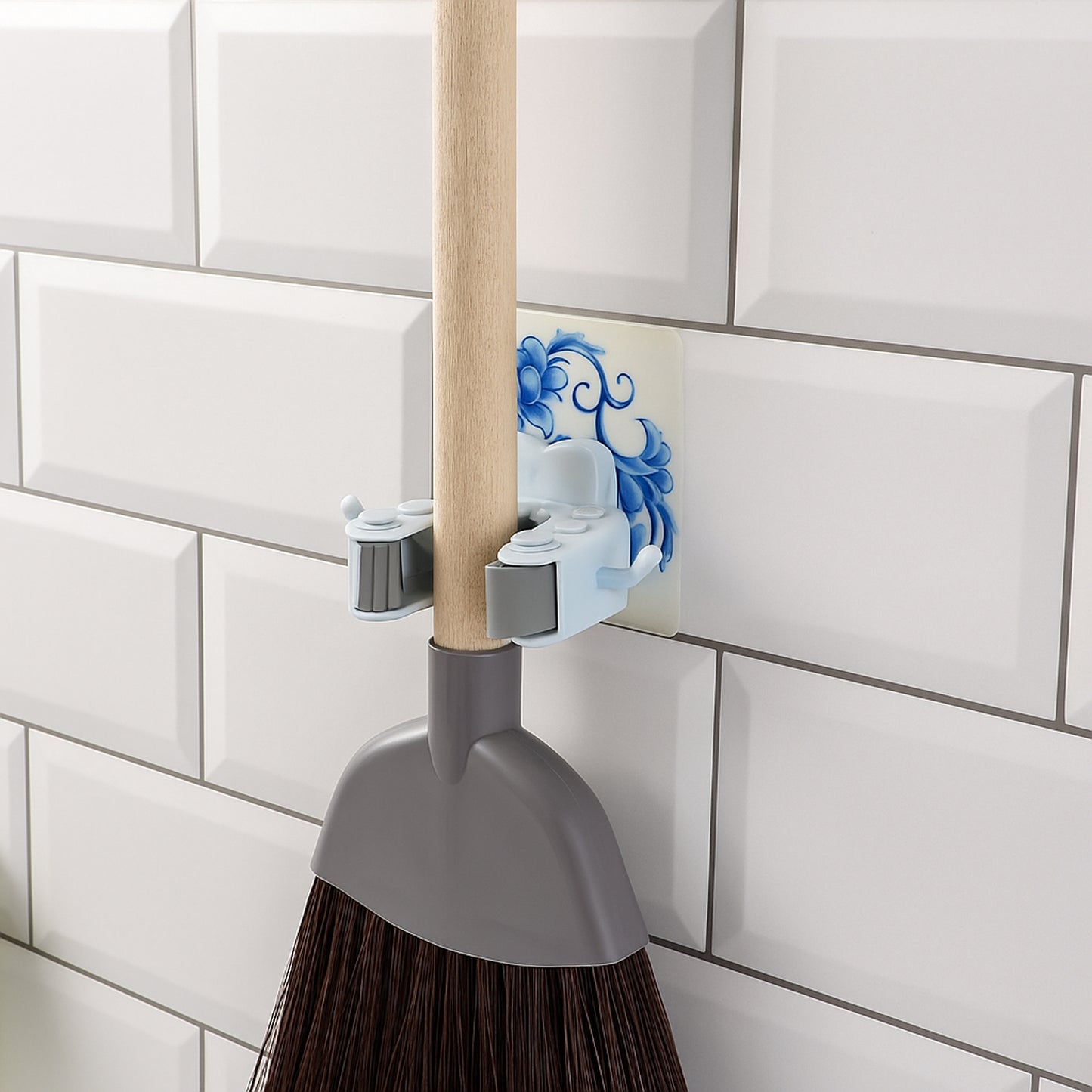 Wukusy wall-mounted mop and broom holder clip attached to a wall, organizing cleaning tools efficiently in a home improvement setting.