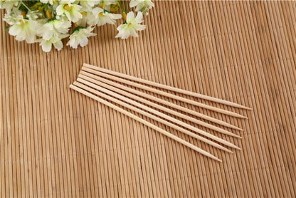 Set of 30cm wooden bamboo BBQ skewers by Wukusy, ideal for shish kebabs, fruit, and meat grilling at outdoor parties.