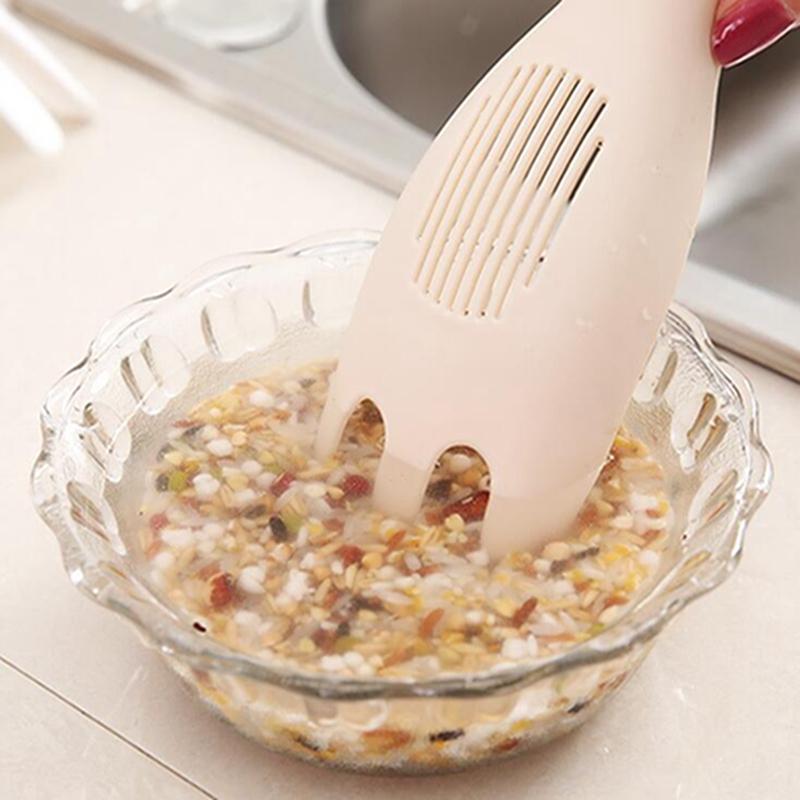 Wukusy rice sieve washer and strainer spoon for rinsing and draining rice in a home kitchen setting.