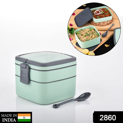 Green double-layer Wukusy portable lunch box with carrying handle and spoon, stackable design for easy meal transport.