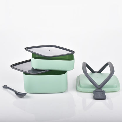 Green Wukusy double-layer portable lunch box with handle and spoon, stackable design for easy carrying and meal organization.