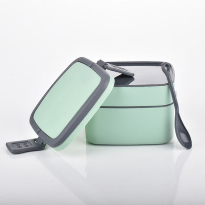 Green double-layer portable lunch box by Wukusy with a carrying handle and spoon, designed for easy stacking and meal on the go.