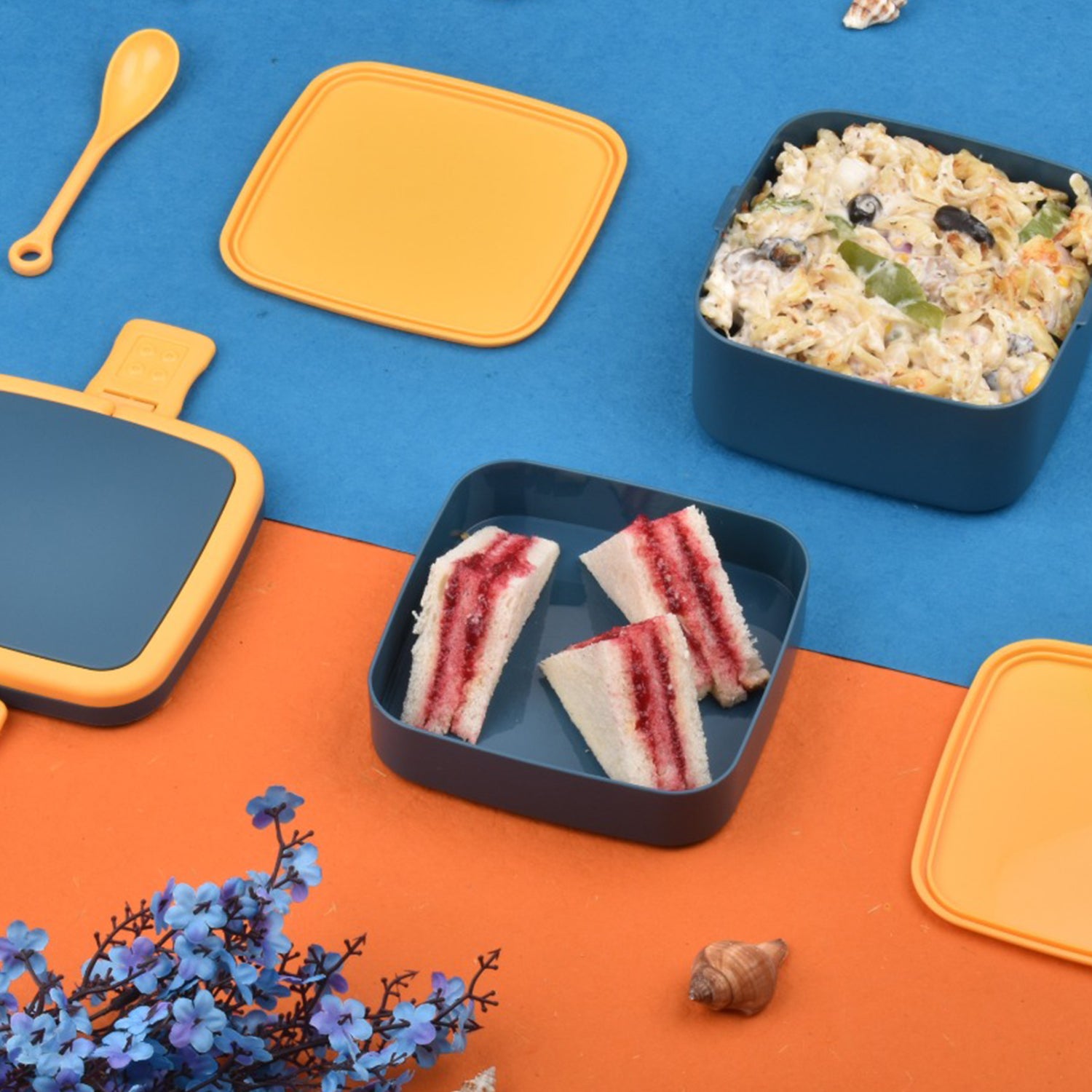 Blue double-layer Wukusy portable lunch box with carrying handle and spoon, stackable design for convenient meal storage.