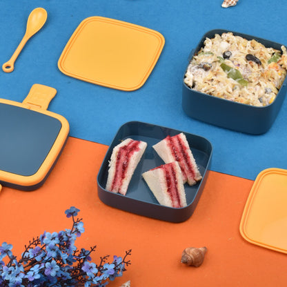 Blue double-layer Wukusy portable lunch box with carrying handle and spoon, stackable design for convenient meal storage.