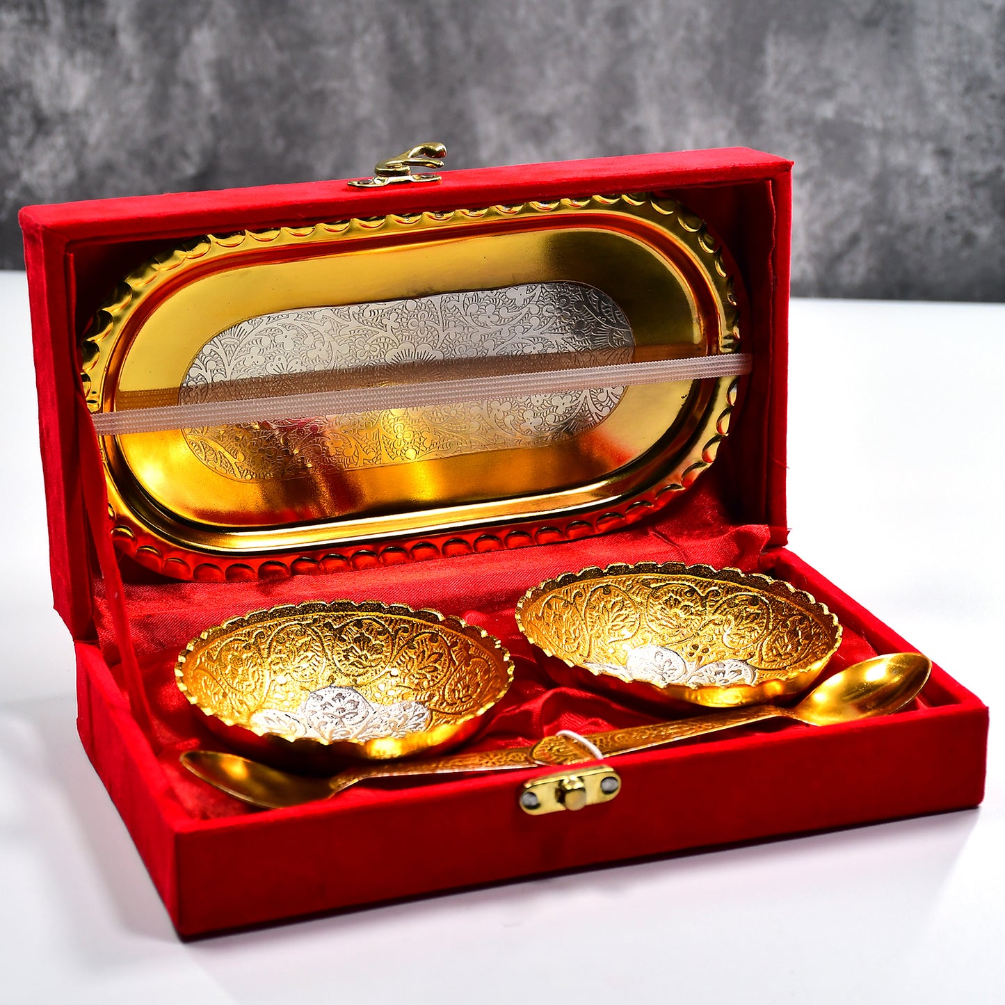Gold and silver plated brass tray set with two bowls and spoons, presented in a red velvet gift box for serving dry fruits or desserts.