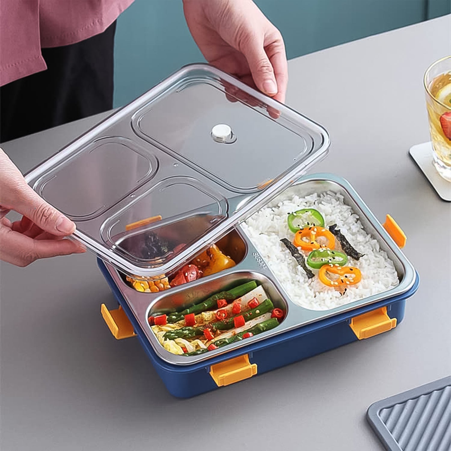 Wukusy 3-compartment transparent stainless steel lunch box with spoon and chopsticks for home and kitchen use.