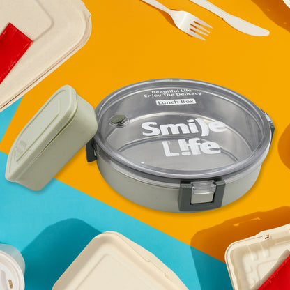 Wukusy Miracle stainless steel round lunch box with transparent lid, includes small plastic insert, leak-proof design for kids and adults.