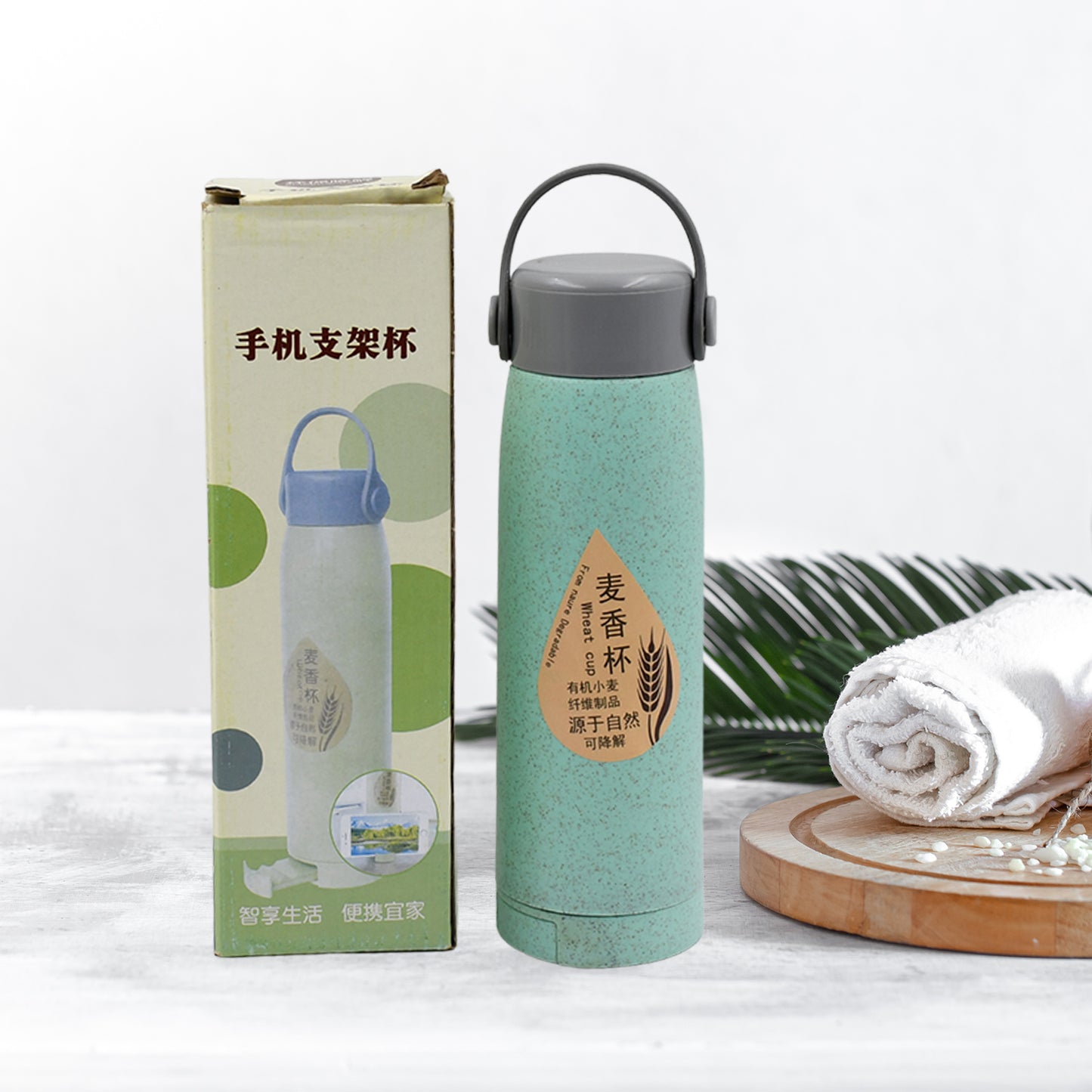 Wukusy 380ml portable glass water bottle with wheat fragrance design, wide mouth, mobile phone holder, and sleek transparent body.