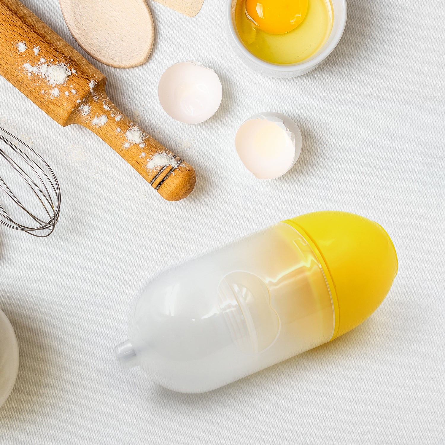 Wukusy manual egg puller and scrambler in white, kitchen tool for mixing egg yolks without breaking eggs, household use.