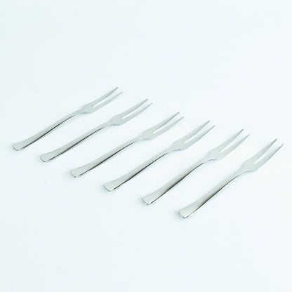 Wukusy Apex 6-in-1 stainless steel fruit fork set with multiple tines for serving and eating fruit in a modern kitchen setting.