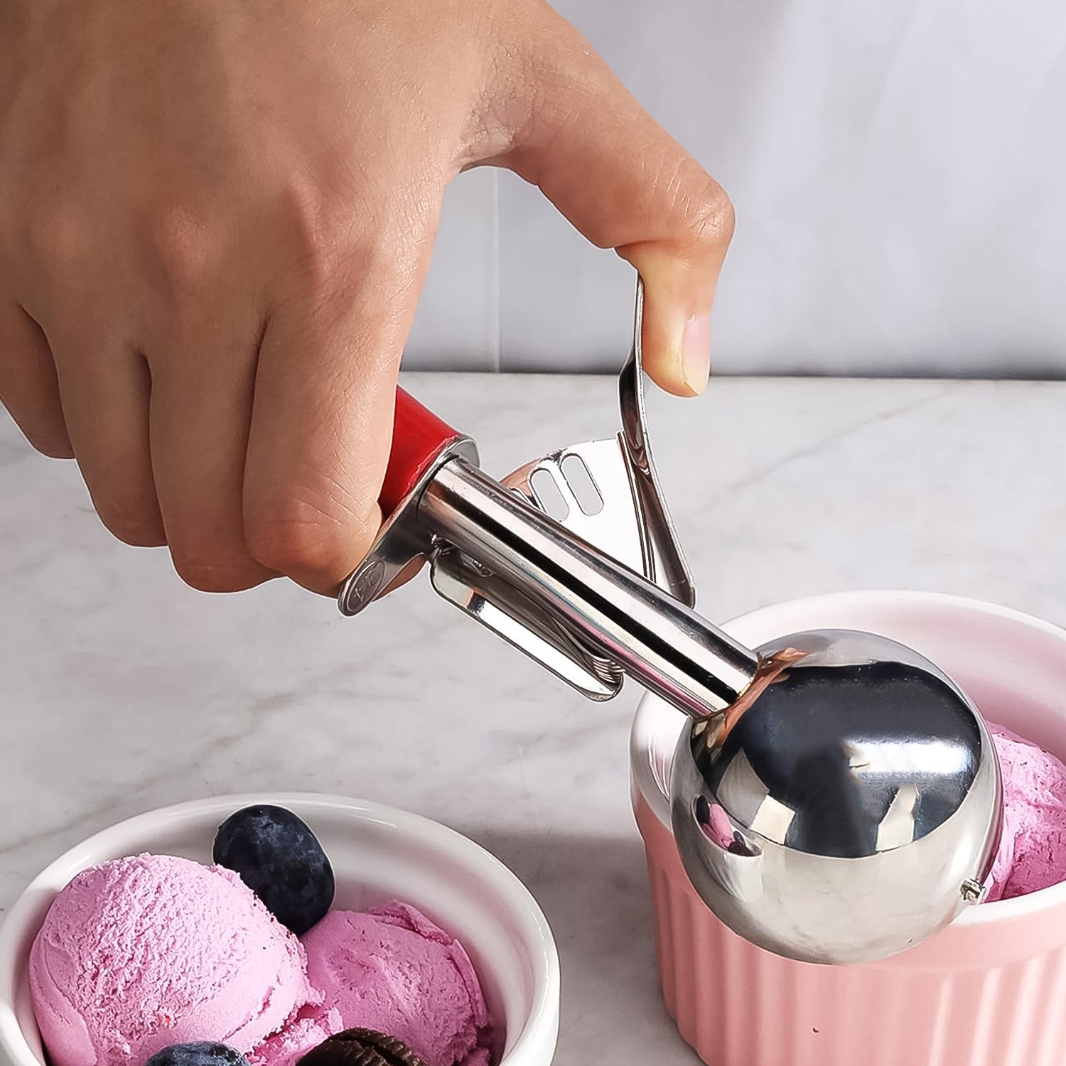 Wukusy Apex ice cream scoop with 70ml stainless steel head and ergonomic handle, ideal for home kitchen use.
