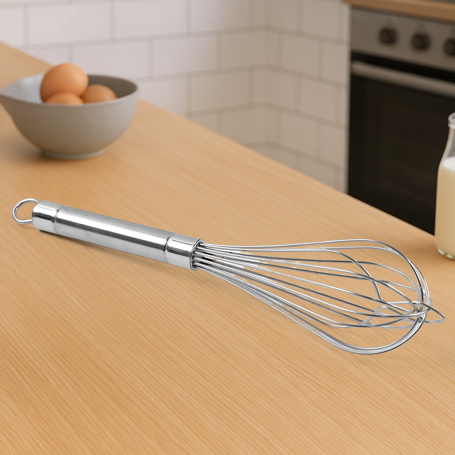 Wukusy Apex stainless steel large hand whisk for mixing and whipping in kitchen, with ergonomic handle and durable construction.