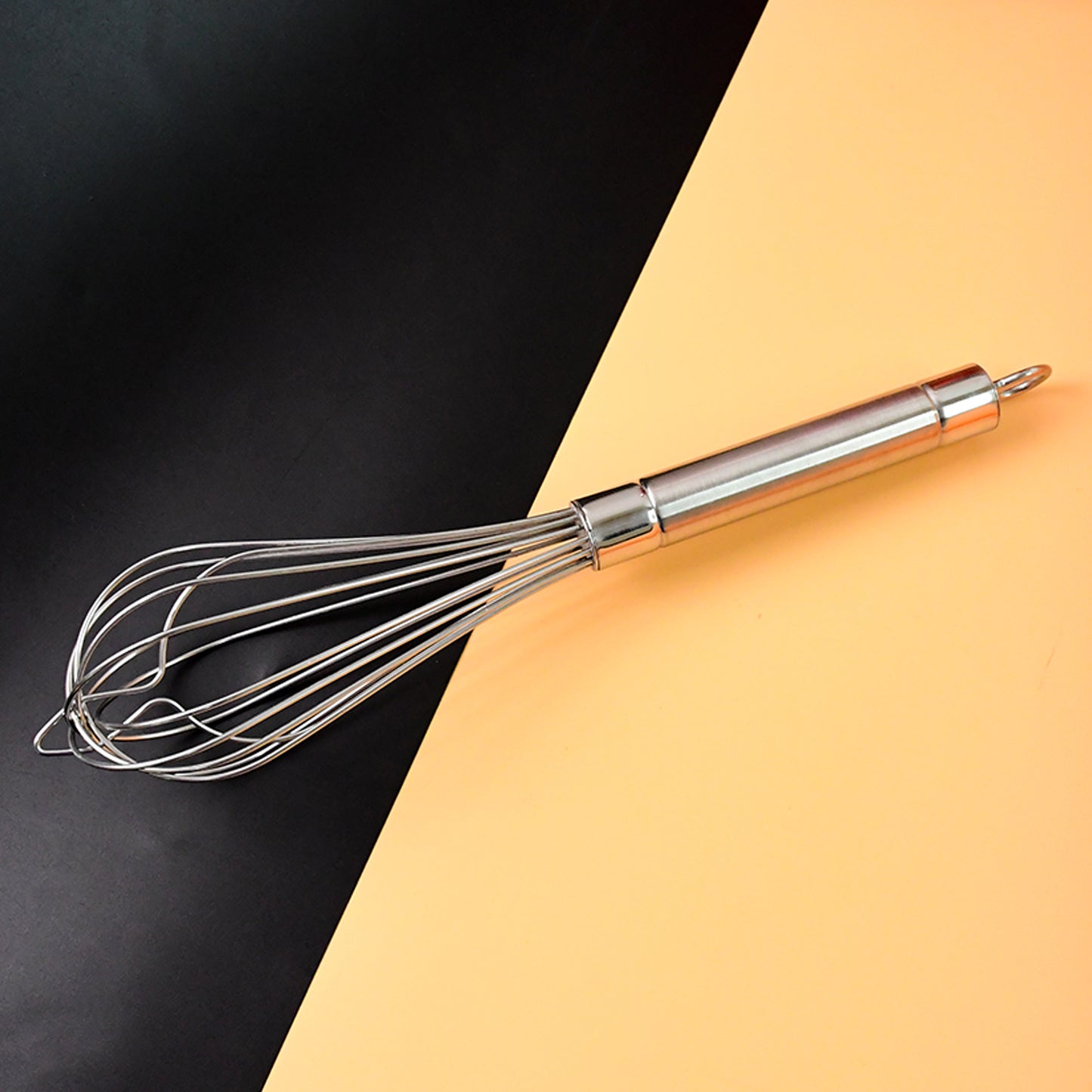 Wukusy Apex stainless steel large hand whisk for baking and cooking, with a sturdy handle and multiple wire loops.