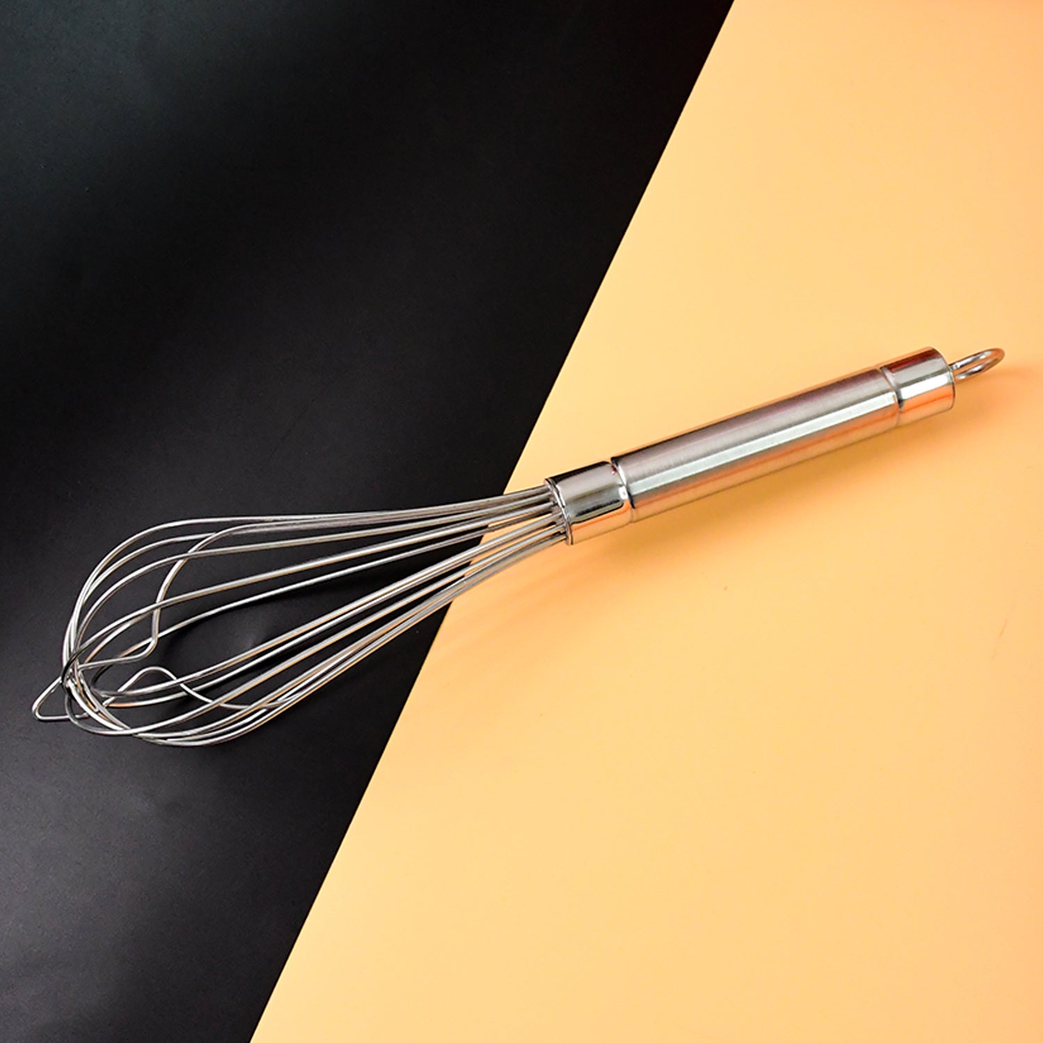Wukusy Apex stainless steel large hand whisk for baking and cooking, with a sturdy handle and multiple wire loops.